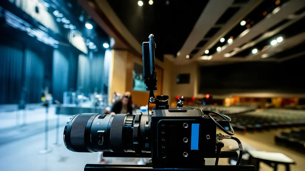a cinema camera on a tripod in a doorway