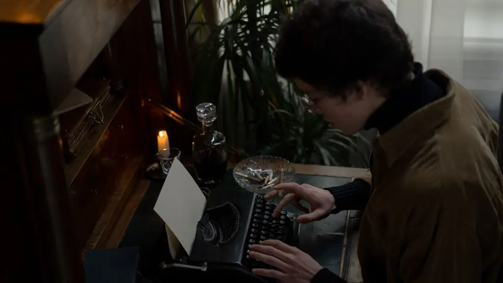 a writer at a café window at night