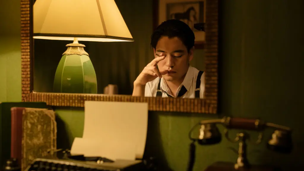 a writer at a café window at night